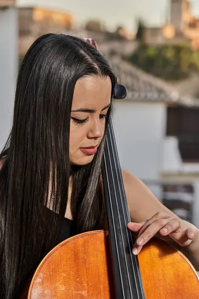 Young lady playing extraordinary music with the cello