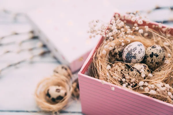 Easter composition of Easter eggs in the nest on the old wooden background.