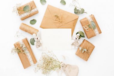Mockup zarf, boş kartı, hediye kutuları ve kuru çiçekler. Düğün kavramı