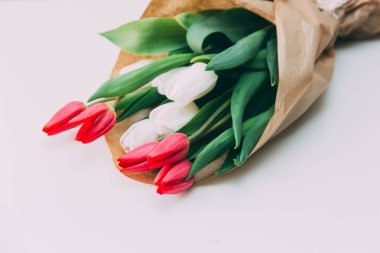 Beyaz masa arka plan üzerinde kırmızı ve beyaz laleler 