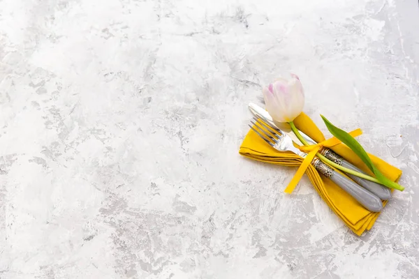 De instelling van de tabel van Pasen met Lentebloemen en bestek. Vakantie achtergrond — Stockfoto