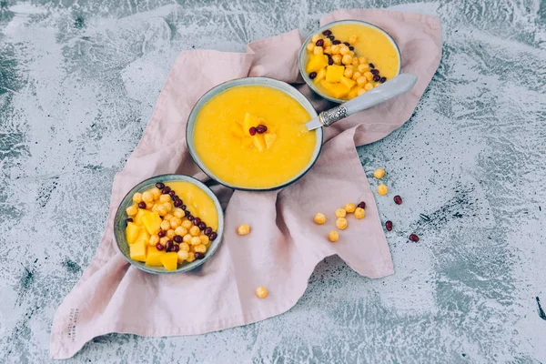 Mango smoothie in bowl. Healthy breakfast. Mango smoothie with cereals