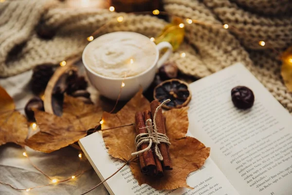 Autumn Cozy fall background with hot coffee cup and decorations. Hipster blogger morning