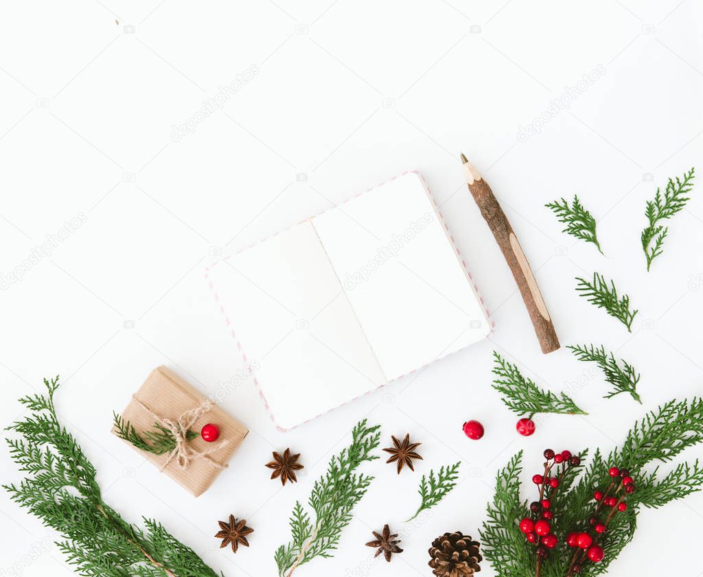 Christmas composition. Flat lay with decorations and notebook. Wish list or goals concept