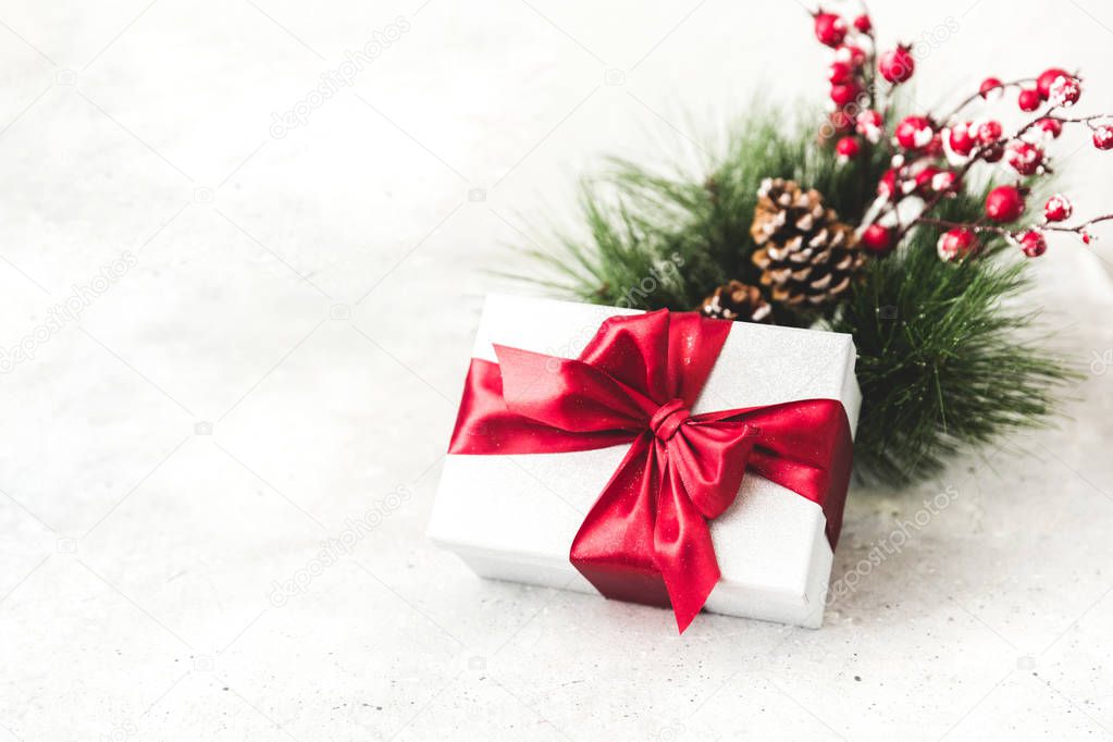 Christmas gift with decorations. Copy space. Present with red bow