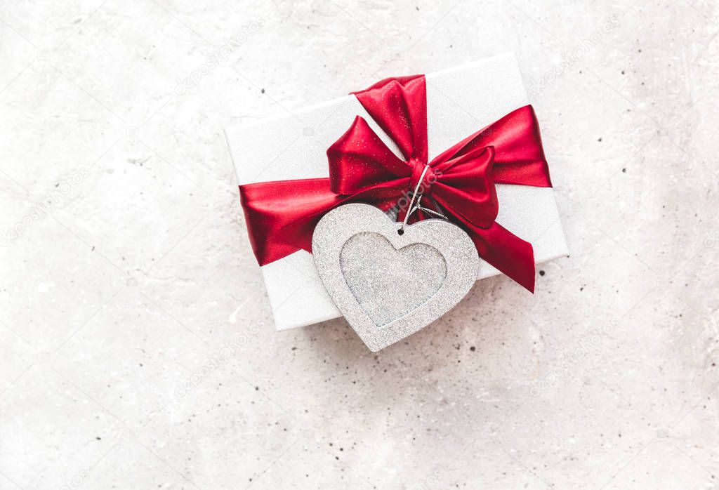 Gift box onvintage background. Red ribbon. Valentine's Day gift.