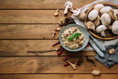 Mantarlı risotto, atış yukarıdan bir yer ile karanlık rustik dokular üzerinde metin için