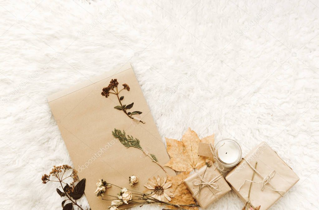 Flat lay composition with wrapped gift box and autumn leaves