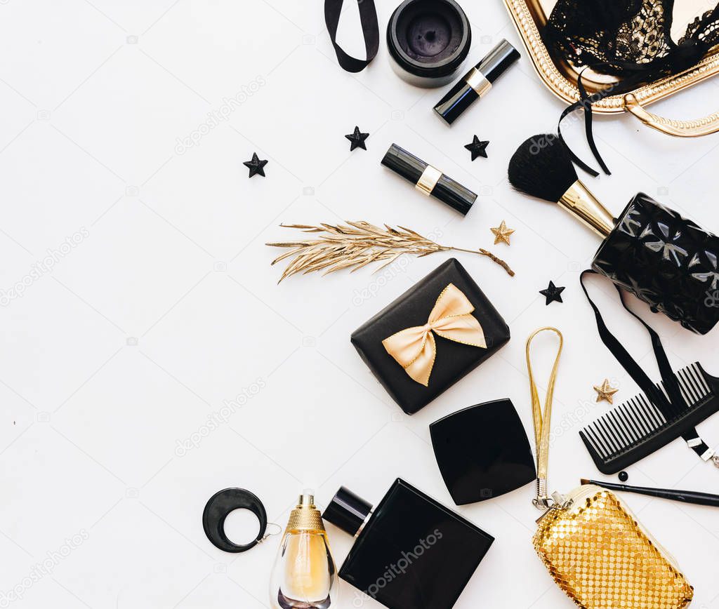 Flat Lay, Beauty blog concept. Female make up and accessories on white background. top view of black and gold trendy fashion feminine background. 