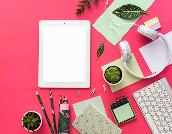 Tablet PC, succulent plants and office supplies over pastel  background. Office table. Flat lay mock up for social media blog