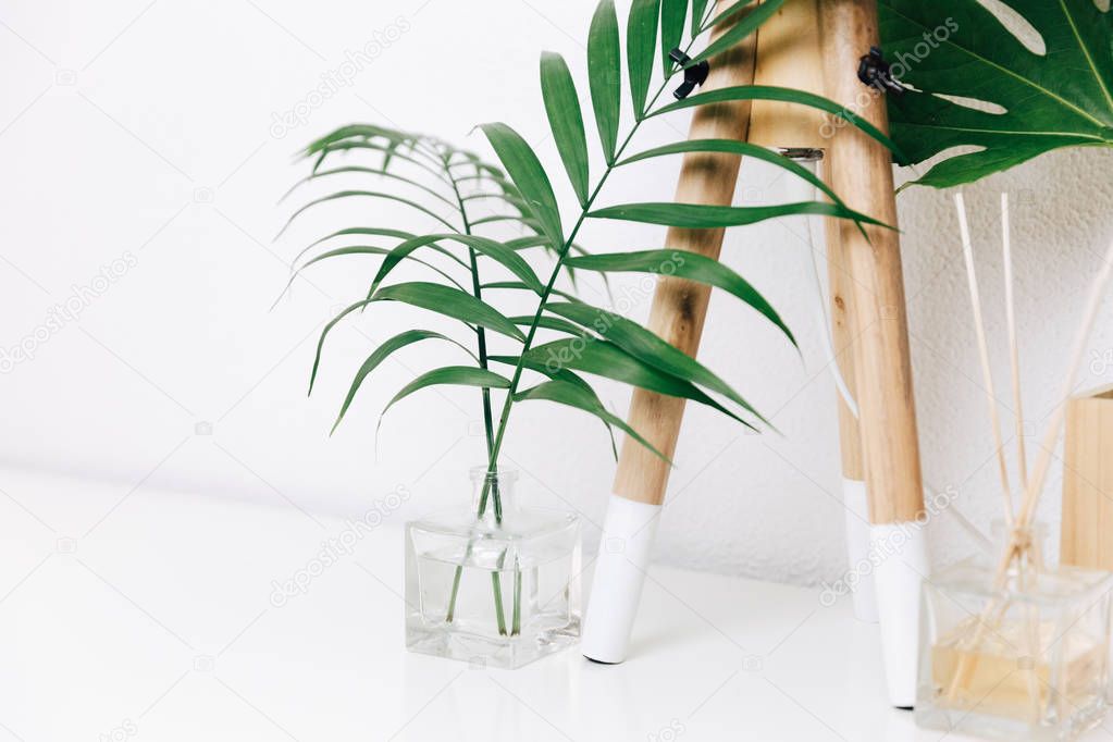 Hipster Scandinavian style room interior. Nordic lamp with tropical leaves. Simple decor objects, minimalist white interior