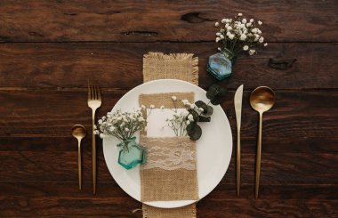 Kırsal düğün masası seti. Dekorasyonlu, çiçekli klasik yemek masası. Boho tarzı. Bir etkinlik, parti, tarih ya da düğün için masa hazır.