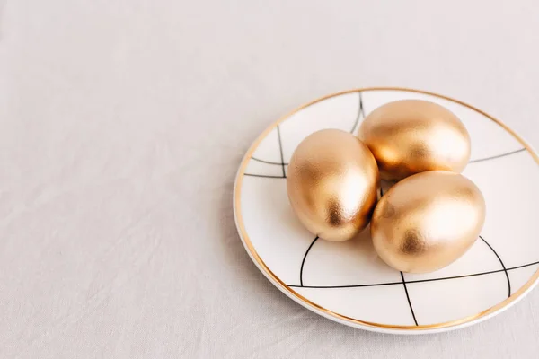 Gold Easter eggs on plate. Happy Easter Background
