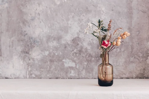 Dried flower in bottle, minimalism in still life. Copy space background