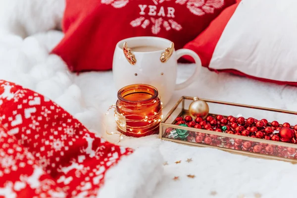 Cup Of Hot Drink With Steam Teddy Bear Candle In Red Christmas Decoration  On Cozy Knitted Plaid In Front Of Fireplace Cozy Magical Atmosphere In Home  Interior Holiday Christmas New Year Concept