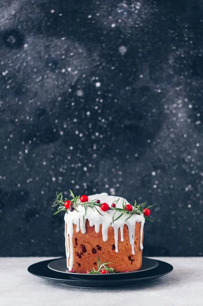 Christmas festive pound cake decorated with cranberries almonds and rosemary twigs