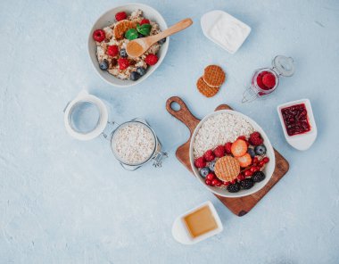 Mavi arka planda böğürtlenli yulaf ezmesi.