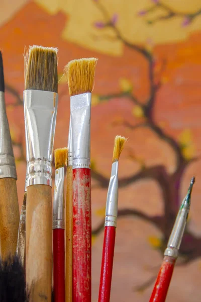 Some Artistic Paintbrushes Front Unfinished Painting — Stock Photo, Image