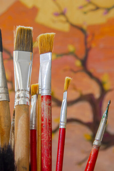 Some Artistic Paintbrushes Front Unfinished Painting Stock Image