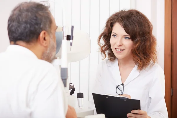 Joven optometrista trabajando en su estudio médico —  Fotos de Stock