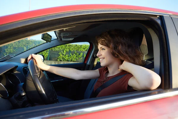 Jovem mulher dirigindo um carro novo — Fotografia de Stock