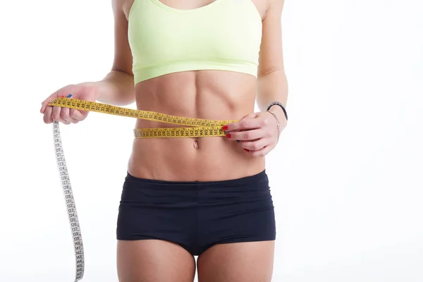 Fit female measuring her waist — Stock Photo, Image