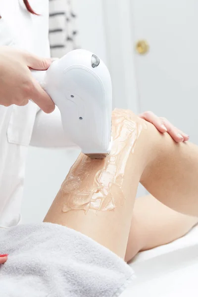 Young woman having legs laser hair removal treatment in salon — Stock Photo, Image