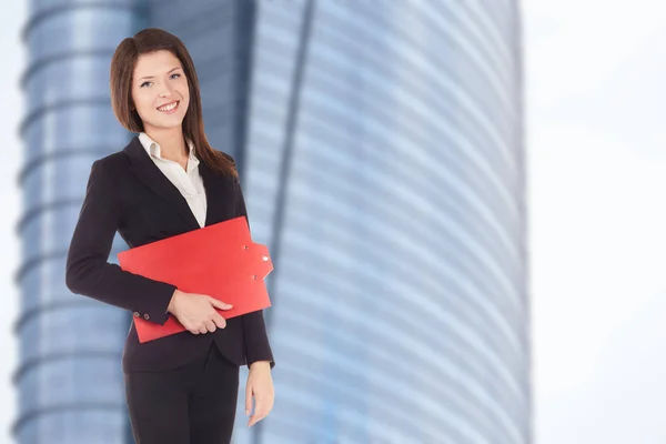 professional business woman smiling outdoor with clipboard in her hands