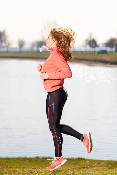 Young healthy lifestyle woman running at sunrise beach — Stock Photo, Image