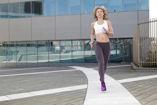 Run woman exercising with urban background