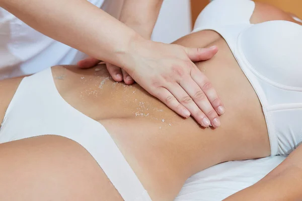 Body Scrub. Beautiful Blonde Gets a Salt Scrub Beauty Treatment in the spa Salon