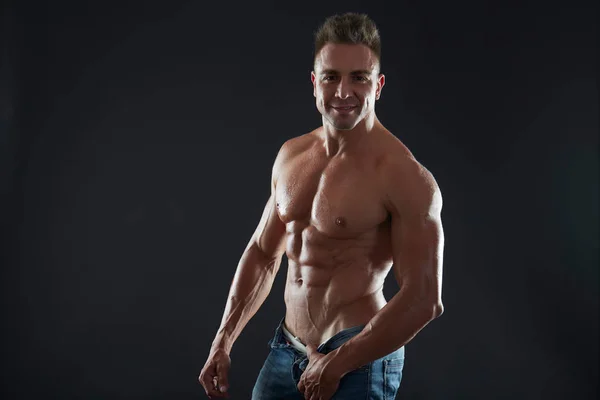 Handsome muscular fit young man on studio background — Stock Photo, Image