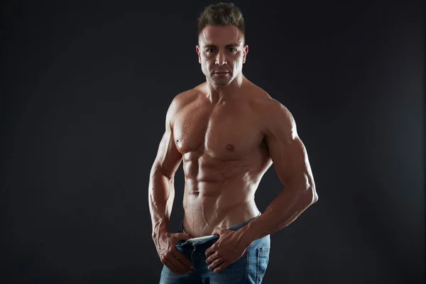 Handsome muscular fit young man on studio background — Stock Photo, Image