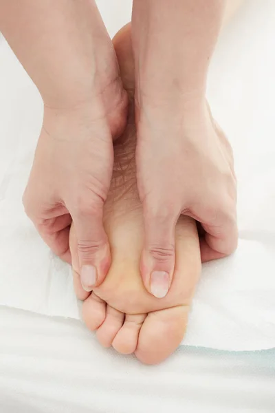 Close-up of female hands doing foot massage — Stock Photo, Image