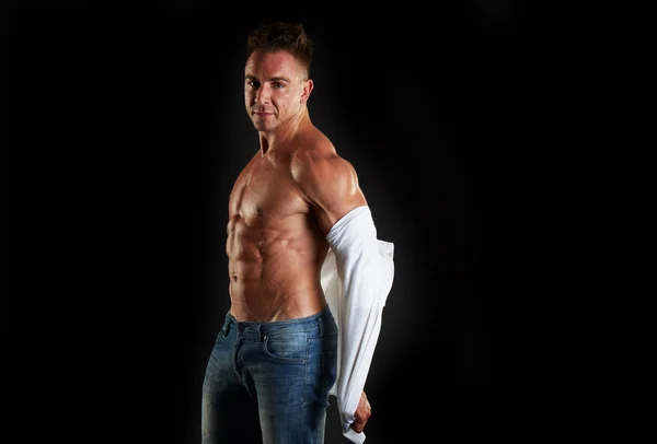 Young sexy muscular man posing in studio background — Stock Photo, Image