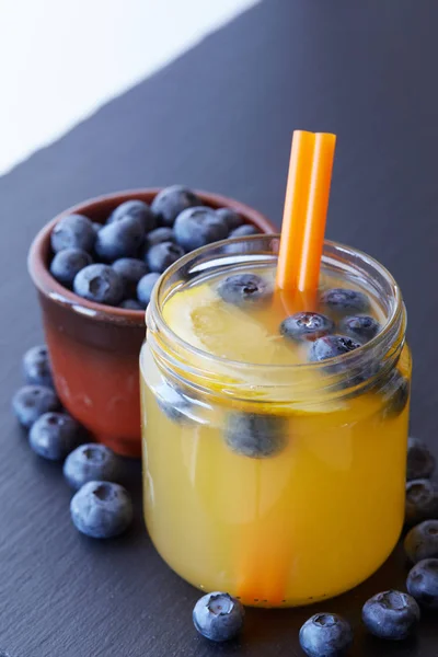 新鲜的的柠檬果汁饮料与蓝莓木制背景 — 图库照片