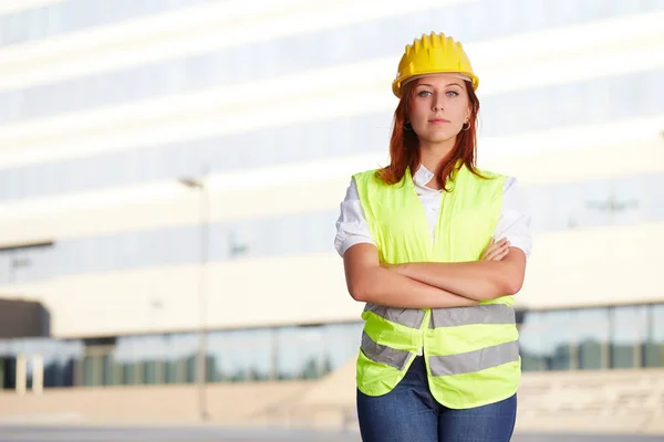 Young female architect/construction engineer at a construction site