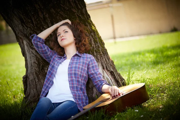 Mulher tocando guitarra no parque — Fotografia de Stock