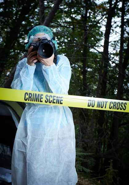 Forensics researcher photographing a blood  at a murder scene — Stock Photo, Image