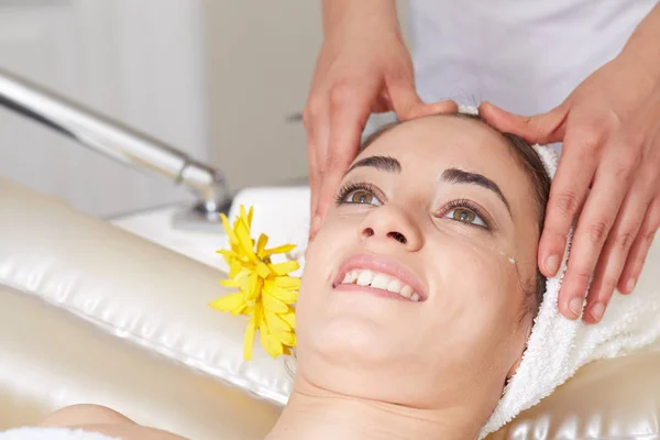 Female Enjoying Relaxing face Massage In Cosmetology Spa Center