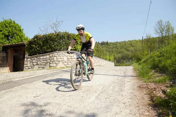 stock image Brescia,Italy, April,22,2018 GF MTB race in Brescia Italy. Lot of bikers in action and village point.