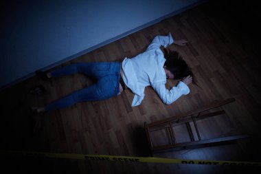 crime scene - woman lying dead on the floor