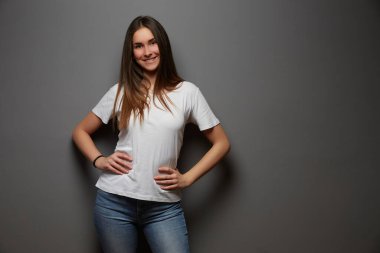 Stüdyo arka planında poz veren genç kız