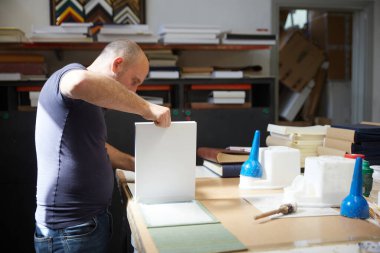 Bir depoda çalışan kitap klasörü.