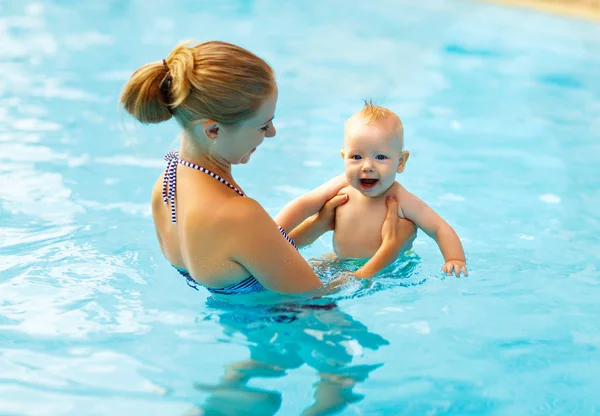 Mother and baby swim  in pool Stock Picture