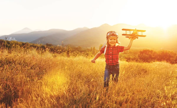 Child pilot aviator with airplane dreams of traveling in summer — Stock Photo, Image