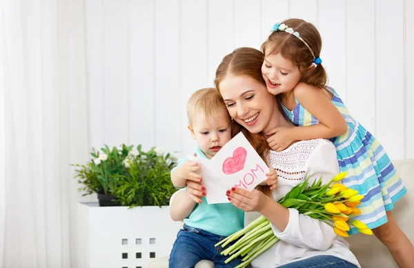 Happy mother's day! Children congratulates moms and gives her a