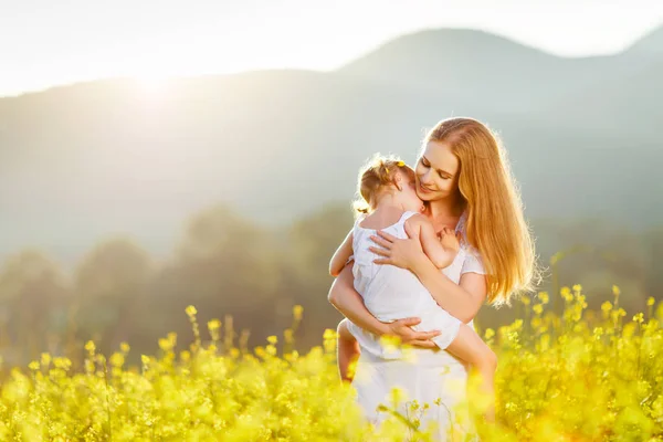 Família feliz mãe e criança filha abraçar na natureza em suma — Fotografia de Stock