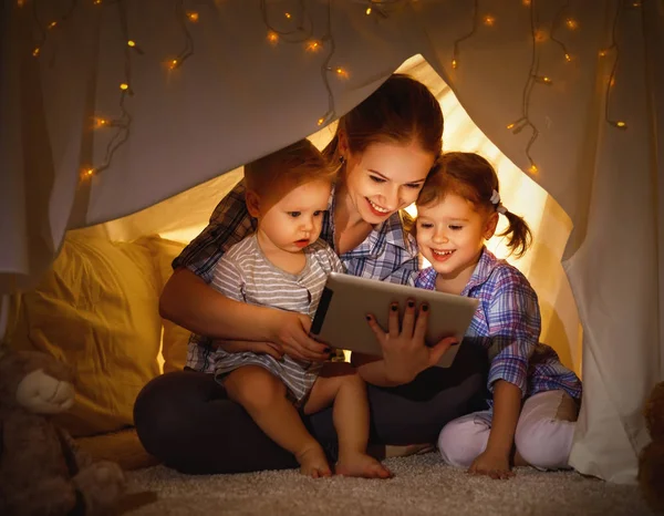 Happy family mother and children playing in tablet  pc — Stock Photo, Image
