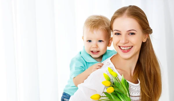 Happy mother's day. Baby son gives flowers for mom — Stock Photo, Image